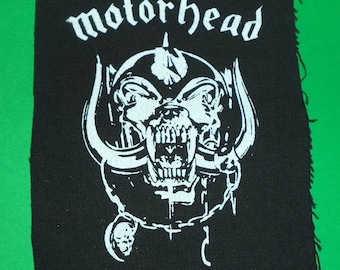 May include: Black and white embroidered patch with the band name "Motorhead" and a snarling, horned skull graphic.