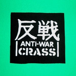 May include: Black and white patch with the text "反戦" in Japanese characters and the words "ANTI-WAR CRASS" in white letters.