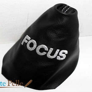 May include: Black leather gear shift boot with white embroidered "FOCUS" lettering.