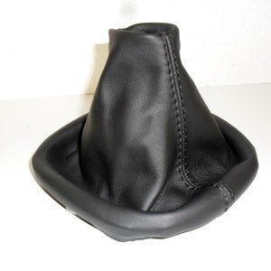 May include: Black leather gear shift boot with a square base and stitched seams.