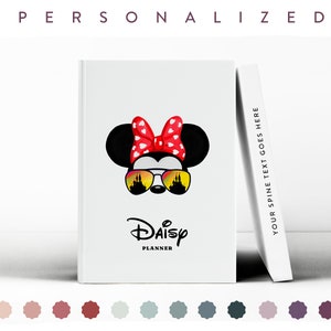 May include: A white planner with a red and white bow, sunglasses with a castle reflection, and the text "Daisy Planner".