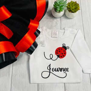 Girls red and black ladybug embroidered shirt