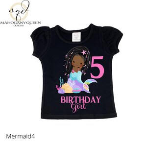 May include: Black t-shirt with a pink mermaid illustration and the number 5. The text "Birthday Girl" is written below the mermaid.