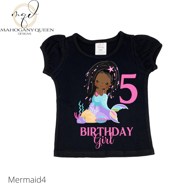 May include: Black t-shirt with a pink mermaid illustration and the number 5. The text "Birthday Girl" is written below the mermaid.