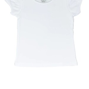 May include: White short-sleeved t-shirt with puffed sleeves. The shirt has a round neckline and a small tag that says "AJ Blanks 2T 100% combed cotton Made in China".