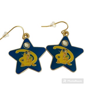 May include: A pair of gold-tone star-shaped earrings with a blue enamel background. The star features a gold-tone Disney 'D' with a cartoon image of Pluto inside. Each earring has a clear rhinestone in the center.