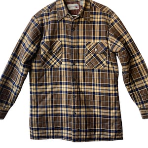 May include: A brown and blue plaid flannel shirt with a button-up front and two chest pockets. The shirt has a quilted lining.