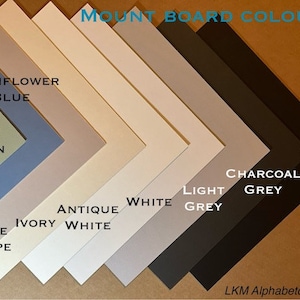 May include: A selection of mount board colours, including sage green, pale taupe, ivory white, antique white, light grey, charcoal grey, and black.