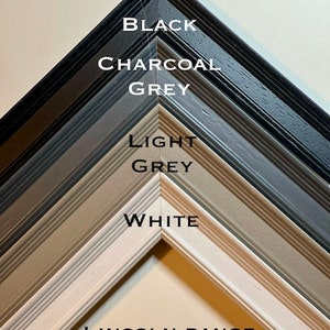 May include: A close-up of five picture frames in different colours: black, charcoal grey, light grey, and white. The frames are all 30mm wide and are part of the Lincoln range.
