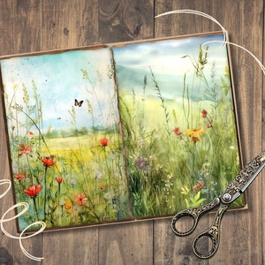 May include: A watercolour painting of a meadow with wildflowers and a butterfly, displayed in an open book. The artwork features vibrant red, yellow, and green hues. Decorative scissors with ornate handles are placed on a wooden surface.