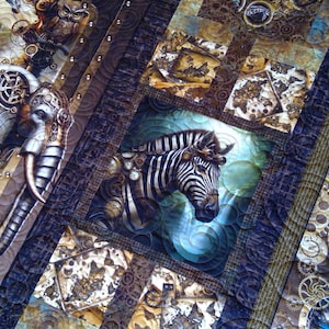 May include: A quilt featuring a patchwork design with steampunk-inspired imagery, including a zebra, an elephant, and a peacock. The fabric displays intricate mechanical gears, clockwork elements, and circular motifs in shades of brown, blue, and gold.
