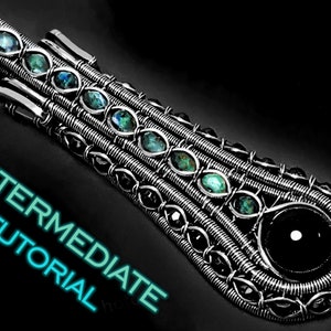 May include: A silver wire wrapped pendant featuring a black gemstone and several green gemstones. The pendant is labelled "INTERMEDIATE TUTORIAL".