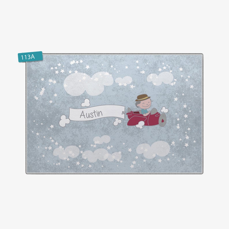 May include: A blue and white personalized nursery rug with a cartoon illustration of a boy flying a red airplane in the clouds. The rug has the name "Austin" on it.