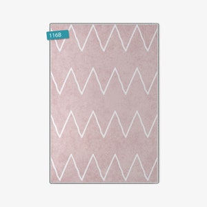May include: A pink rug with a white chevron pattern. The rug has the number "116B" printed on a blue tag.