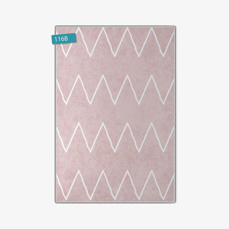May include: A pink rug with a white chevron pattern. The rug has the number "116B" printed on a blue tag.