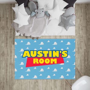 May include: A blue and white rug with a white cloud pattern. The rug has a red and yellow banner with the text "AUSTIN'S ROOM" in yellow letters.