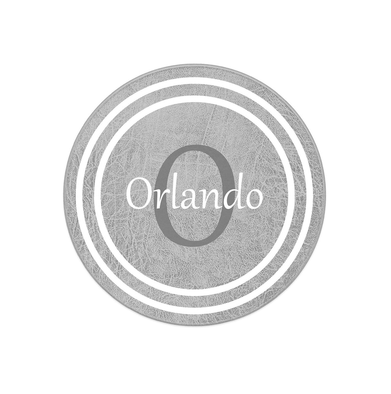 May include: A gray round coaster with a white double ring border and the text "Orlando" and the number "0" in the center.
