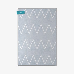 May include: A light blue rug with a white chevron pattern. The rug has a subtle texture and is perfect for adding a touch of modern style to any room.