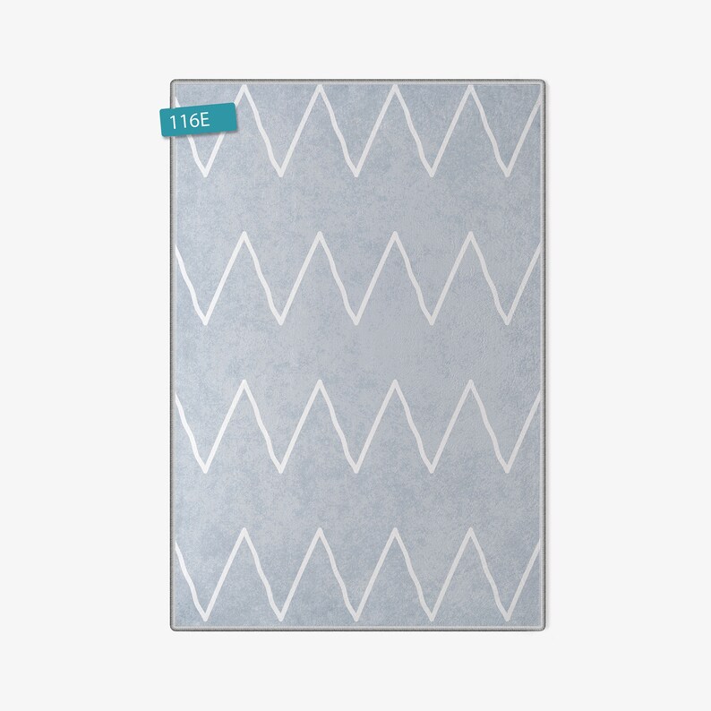 May include: A light blue rug with a white chevron pattern. The rug has a subtle texture and is perfect for adding a touch of modern style to any room.
