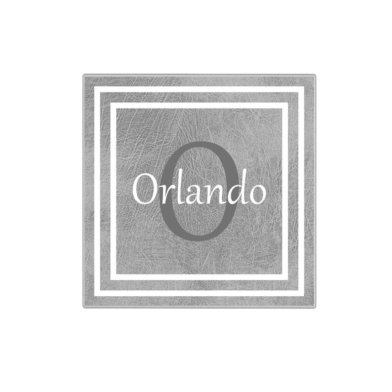 May include: A gray square with a white border and a white double border. The center of the square has a gray leather texture with a large gray letter "O" and the word "Orlando" in white text.