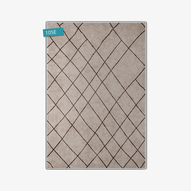 May include: A beige rug with a geometric pattern of brown lines forming a diamond shape. The rug has the number "105E" printed on a blue label in the top left corner.