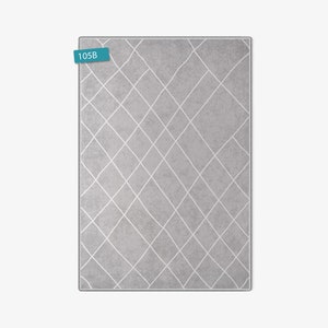 May include: A gray area rug with a white diamond pattern. The rug has the number 105B printed on a blue label.