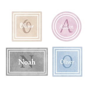 May include: Four personalized name signs with different colors and designs. The names are Oliver, Aidan, Noah, and Oliver.