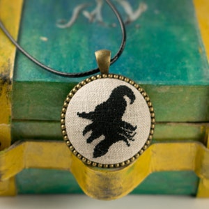 Witch Silhouette Pendant: Black Embroidery, Rustic Linen, Bronze Tone