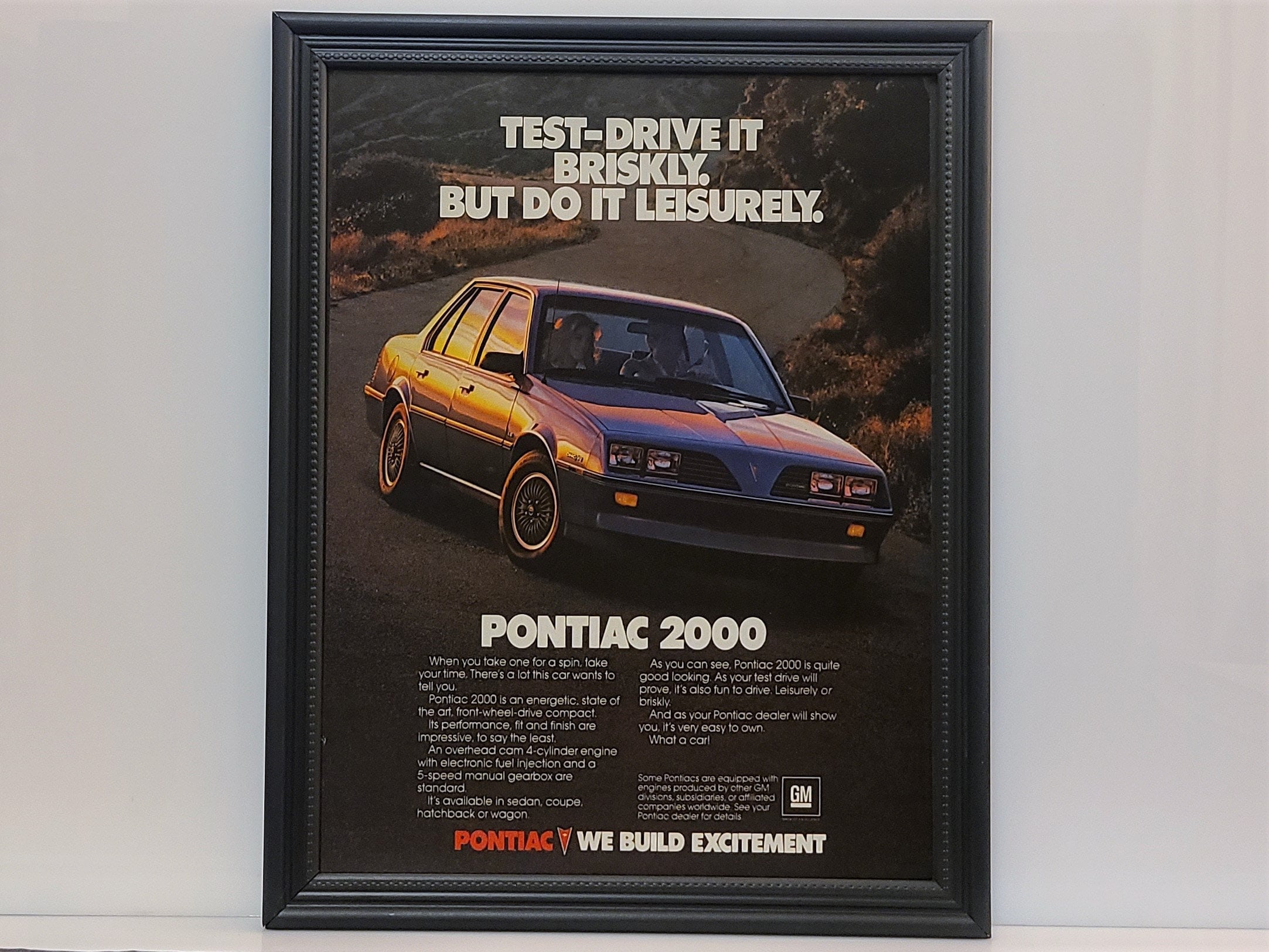 Framed 80's Car Ad 1983 Pontiac 2000 Retro Advertisement
