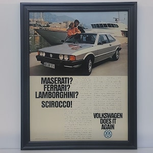 May include: A vintage print advertisement for the Volkswagen Scirocco. The ad features a silver Scirocco car parked in front of a yacht and a cityscape. The text reads "Maserati? Ferrari? Lamborghini? Scirocco! Volkswagen Does It Again."