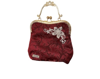Vintage Inspired Burgundy Handbag with Rhinestone Brooch and Clasp Closure