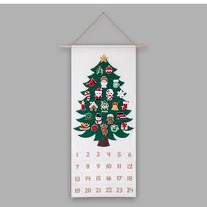 May include: A felt Christmas tree advent calendar with 24 numbered pockets and festive illustrations of Santa, reindeer, gingerbread houses, and other holiday icons.