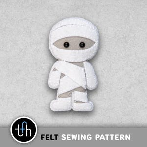 May include: A white felt mummy figure with stitched details, gray eyes, and wrapped bandages. The figure is standing upright. The text "FELT SEWING PATTERN" is below the figure.