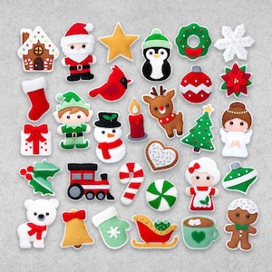May include: A set of 25 felt Christmas ornaments featuring various holiday themes, including a gingerbread house, Santa Claus, a penguin, a snowman, a reindeer, a Christmas tree, a candy cane, a bell, a stocking, a star, a wreath, a snowflake, a poinsettia, a present, a gingerbread man, a polar bear, a hot chocolate mug, a peppermint candy, a sleigh, a candle, a holly sprig, and a Christmas ornament.