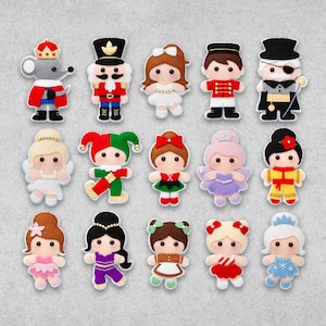 May include: A set of 15 felt ornaments featuring characters from the Nutcracker ballet. The ornaments are colourful and feature a variety of characters, including the Nutcracker, Clara, the Mouse King, and the Sugar Plum Fairy.