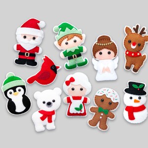 May include: A set of ten felt Christmas ornaments featuring a penguin, Santa Claus, a gingerbread man, a snowman, an elf, a reindeer, a cardinal, a polar bear, a girl in a red dress, and an angel.