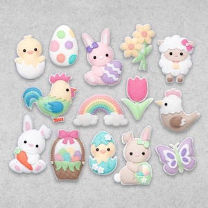 Könnte beinhalten: Ein Set an Filz-Ostereiern mit einem Regenbogen, Küken, Hasen, Blume, Ei, Hahn, Lamm, Schmetterling und einem Korb mit Eiern.