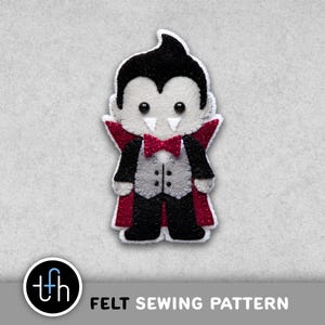 May include: A felt vampire doll with a black cape, red accents, and a bow tie. The doll has a white face, black hair, and a grey waistcoat. The text "FELT SEWING PATTERN" is at the bottom.