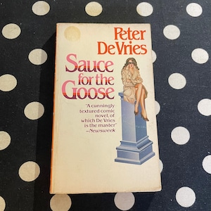 May include: A book cover with a pink, white, and orange background. The title is "Sauce for the Goose" by Peter De Vries. The cover features a woman in a long coat sitting on a stone bench. The quote "A cunningly textured comic novel, of which De Vries is the master" - Newsweek is printed on the cover.