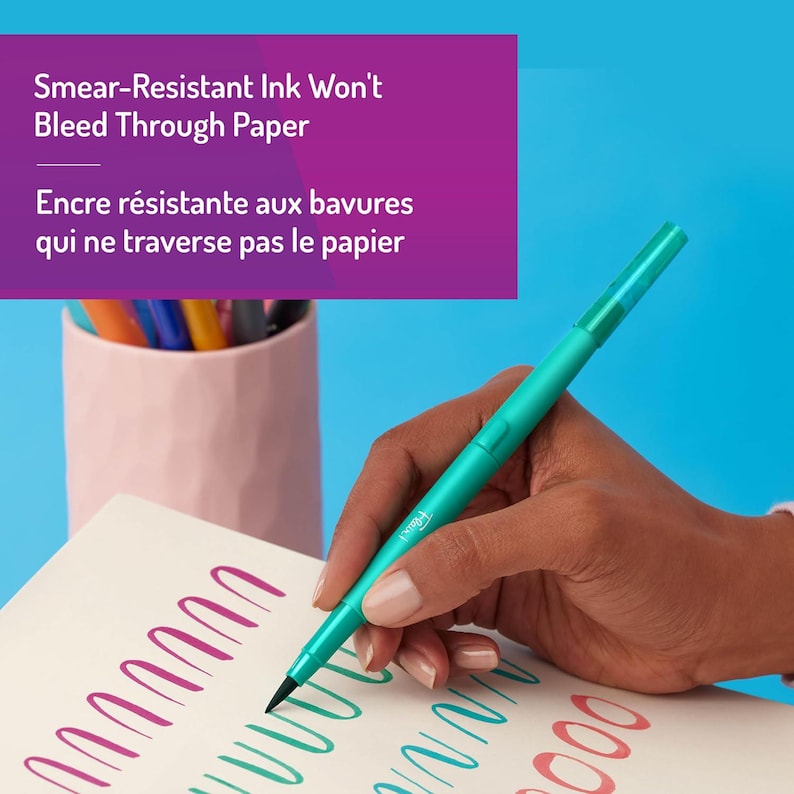May include: A teal pen with a black tip is held over a white paper with colorful ink strokes. The text "Smear-Resistant Ink Won't Bleed Through Paper" and "Encre r&eacute;sistante aux bavures qui ne traverse pas le papier" are visible.
