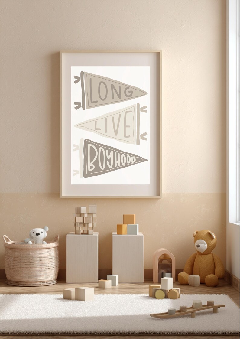 May include: A framed print with the words "LONG LIVE BOYHOOD" in a neutral color palette hangs above a rug. The room is decorated with toys, including a teddy bear, wooden blocks, and a basket with a stuffed animal.