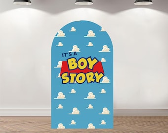 May include: A large, arched backdrop with a blue sky and cloud pattern. The text "IT'S A BOY STORY" is displayed in yellow and red. The backdrop is designed for a baby shower or themed party.
