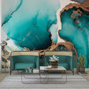 May include: A modern living room setting with two teal armchairs, a marble coffee table, and a patterned rug. The wall features a teal and gold abstract mural. The room is designed with contemporary furniture and decor.