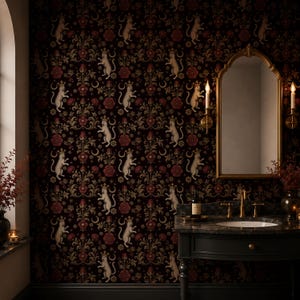 May include: Dark wallpaper featuring a repeating pattern of white cat figures, red flowers, and gold floral accents. The wallpaper is in a bathroom with a gold-framed mirror and a black vanity.