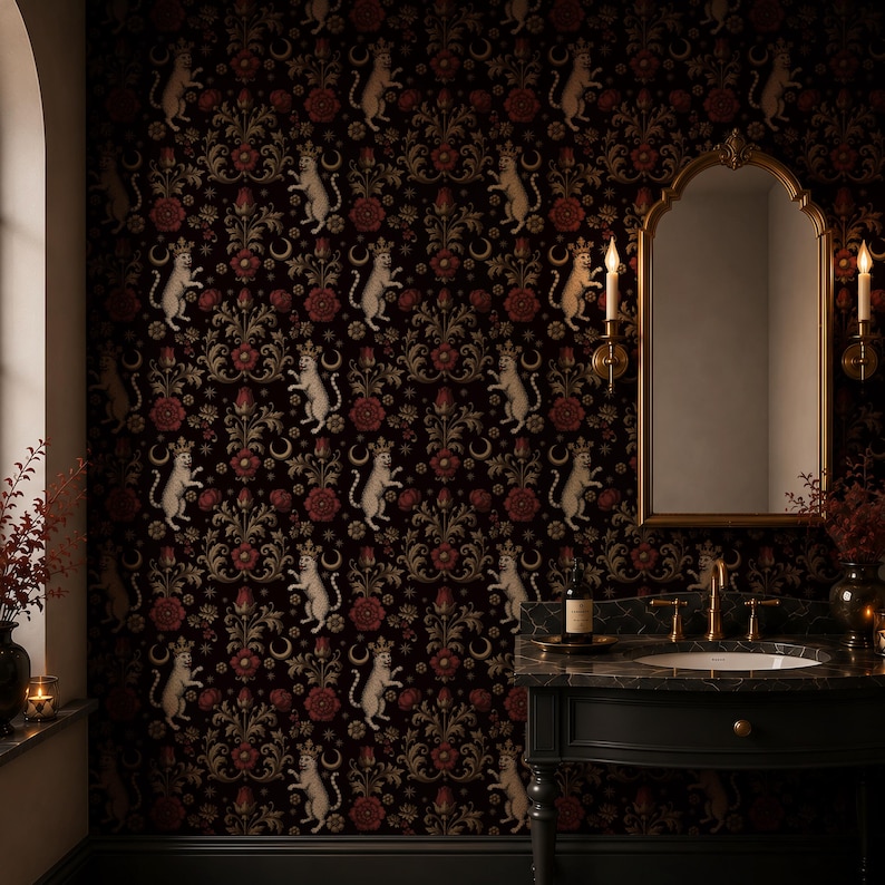 May include: Dark wallpaper featuring a repeating pattern of white cat figures, red flowers, and gold floral accents. The wallpaper is in a bathroom with a gold-framed mirror and a black vanity.