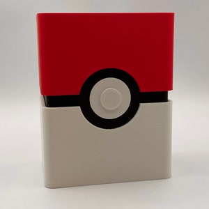 May include: A red and white Pokemon card deck box with a black Pokeball design.