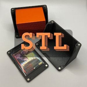 May include: A black 3D printed card holder with a removable lid. The holder is designed to store and display trading cards. The holder is shown with a single card inside and a stack of cards in the lid.
