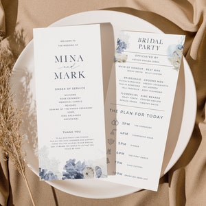 May include: Wedding ceremony order of service and bridal party information cards with a watercolor floral design in shades of blue and gray. The cards feature the names Mina and Mark, the wedding date, and a list of the wedding party members.