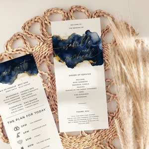 May include: Wedding ceremony order of service and bridal party list with a navy blue and gold watercolor background. The order of service includes the welcome, rose ceremony, memorial candle, reading, joining of the hands ceremony, vows, ring exchange, and recessional. The bridal party list includes the maid of honor, best man, bridesmaids, groomsmen, flower girl, and ring bearer.