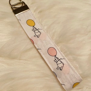 Winnie the pooh with a balloon wristlet lanyard keychain
